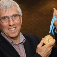 Jeff Kelly Lowenstein, the fourth endowed professor of civil discourse, poses with his medallion